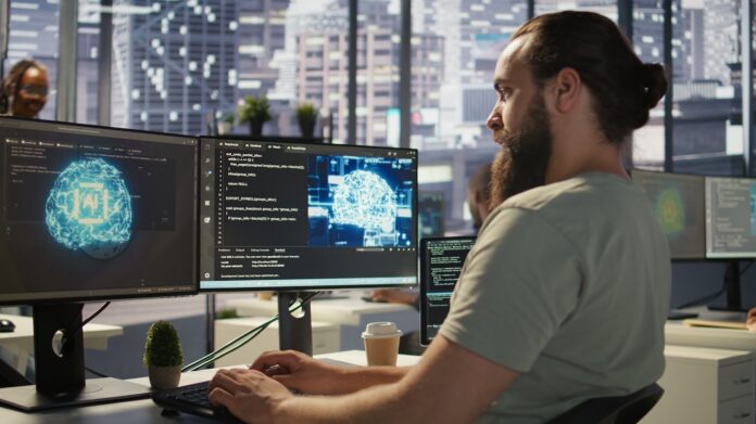 ki tools chatgpt startups einsatz Startup Mitarbeiter der am Computer mit einer Künstlichen Intelligenz arbeitetr