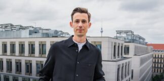 project-a-ventures-philipp-werner-gruender-tipps–Portraits–Philipp–PressPortrait Philipp Werner in Berlin auf einer Dachterasse mit einigen Hochhäusern im Hintergrund