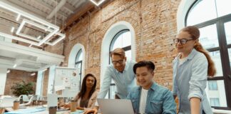 Business Case Managers man and woman in bright modern office. Collaborative efforts to achieve success. Lifestyle of multinational team of businessmen and women in workplace